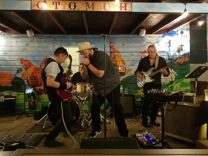 Brandon Santini, an American roots rock and blues harmonica player, performs at Cottonmouth Southern Soul Kitchen in the Village of the Arts, Bradenton, Florida, October 2, 2021.